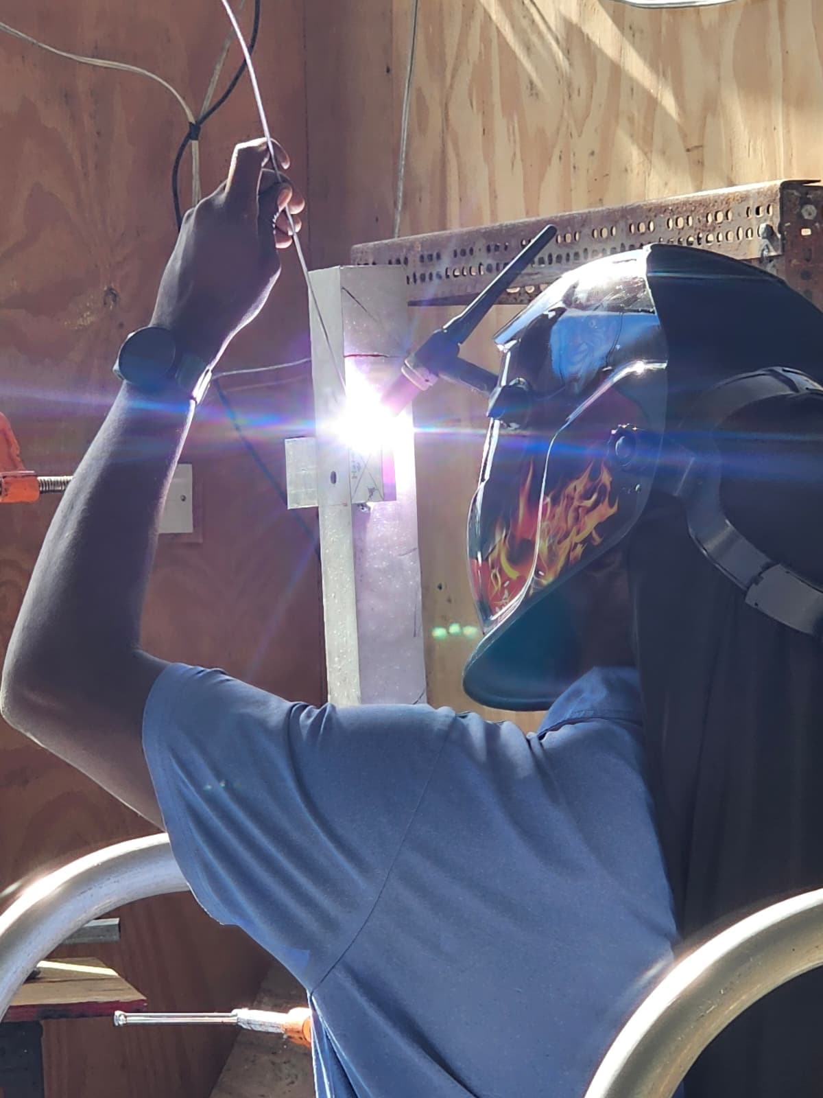 TIG-welding a vertical joint, filler rod in hand